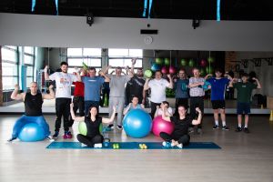 Pamietkowe zdjęcie osób obecnych na wydarzeniu w sali do ćwiczeń